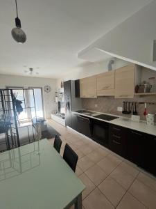 a kitchen with a table and a dining room at Casa da Matti in Gravedona