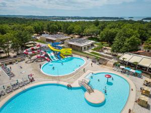 an overhead view of a water park with two pools at Albatross Mobile Homes on Camping Bijela Uvala in Poreč