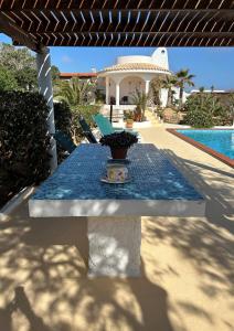 a table with a vase on it on a patio at Oasi Di Casablanca in Lampedusa