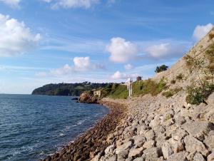 a rocky shoreline next to a body of water at Park View House Close to Central Park and Plymouth Argyle FC - Dogs welcome - Hosted by Absolute Accommodation Plymouth in Plymouth