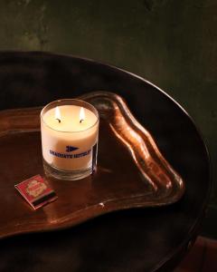 a candle on a table with a snake around it at Graduate by Hilton Palo Alto in Palo Alto