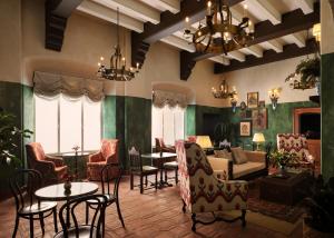 a living room with chairs and a couch and a table at Graduate by Hilton Palo Alto in Palo Alto