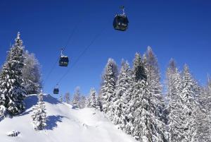 a ski lift in the snow with snow covered trees at Club Alpina - Champagny-en-Vanoise in Champagny-en-Vanoise