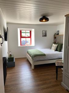 a bedroom with a bed and a window at Farm Stay at THE GLEBE COTTAGE KILREA in Tamlaght