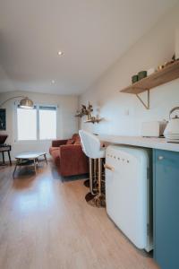 a kitchen and living room with a couch and a table at Doubs Moment in Serre-lès-Sapins