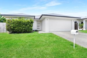 a house with a driveway and a garage at Villa Cattana in Smithfield