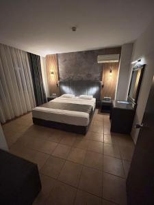 a bedroom with a large bed in a room at Club Sidar Apart Hotel in Alanya