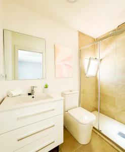 a bathroom with a sink and a toilet and a shower at Costa by Hawkins Algeciras - Atico in Algeciras +12 photos