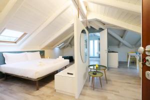 a bedroom with a bed and a table in a room at Palazzo Belli in Alba