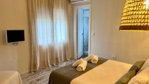 a hotel room with a bed and a large window at Zahora Beach Room in Zahora
