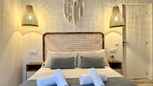 a bedroom with a large bed with two pillows at Zahora Beach Room in Zahora