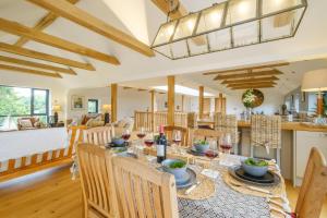 a dining room and living room with a table and chairs at Sandown in Snape