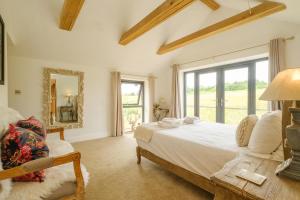 a bedroom with a bed and a large window at Sandown in Snape