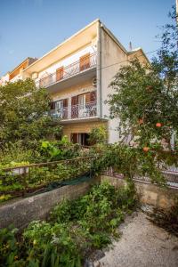 an apartment building with a garden in front of it at Apartments Nuic in Makarska