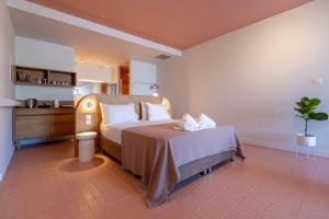 a hotel room with a bed and a bathroom at Leisure Escape with a sea view by Salt Apartments in Volos