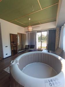 a living room with a large tub in the middle at Saules Club Apart Hotel in Saulkrasti
