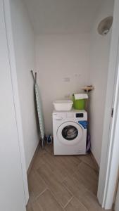 a small bathroom with a washing machine in a room at La casa delle rose 3 in Giba