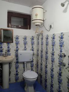 a bathroom with a toilet and a sink at Anchal House in Dharamshala