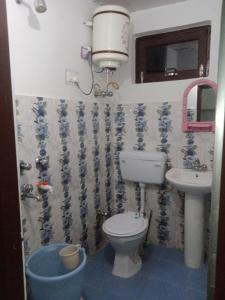 a bathroom with a toilet and a sink at Anchal House in Dharamshala +14 photos