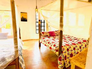 a bedroom with a bed and a couch in a room at Sonofjohnhomestay in Karatu