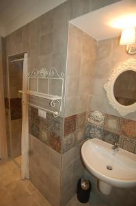 a bathroom with a sink and a mirror at Domus Aurea in Martina Franca