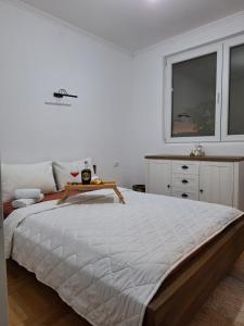 a bedroom with a large bed with a table on it at Slatinska idila - kuća sa bazenom in Bunar