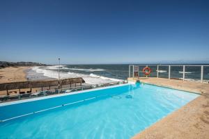 a swimming pool with a view of the ocean at Seagull 401 in Margate