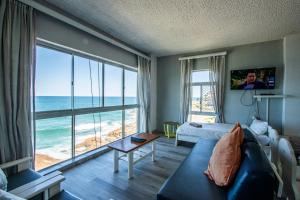 a living room with a view of the ocean at Seagull 401 in Margate