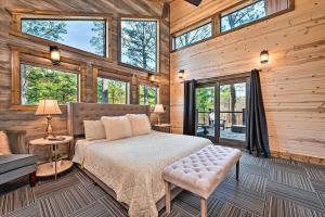 a bedroom with a bed in a wooden cabin at Family Getaway, Hot Tub, Firepit! in Broken Bow +28 photos
