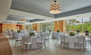 a banquet hall with white tables and chairs at Graduate by Hilton Cincinnati in Cincinnati