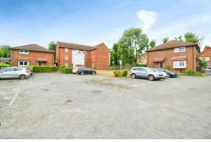a parking lot with cars parked in front of brick houses at 1 Bed House Sleeps 2 -Free Parking -Tv in Romford