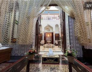 a lobby with a fountain in the middle of a building at Dar Yassine in Rabat
