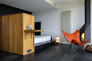 1 dormitorio con 1 cama y 1 silla naranja en Consolación, en Monroyo 37 fotos más