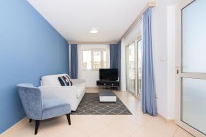 een woonkamer met een bank en een tv bij Garden Palace - Vitamin Sea Appartment with Teracce in Umag