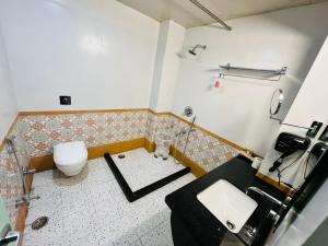 a bathroom with a toilet and a sink at The Jais Boutique Stay in Varanasi +39 photos