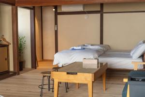 Postel nebo postele na pokoji v ubytování 篠山城下町ゲストハウス inosica