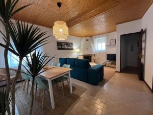 a living room with a blue couch and a table at Escapada amarela SPA et détente in Mariquiteira