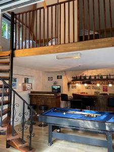 a pool table in a room with a staircase at Carpe Diem met bar biljart en sauna in Lochem