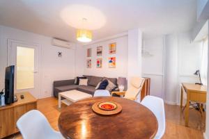 a living room with a table and a couch at Authentic Alicante Central Flat near the Beach in Alicante