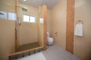 a bathroom with a shower and a toilet at Farish Self Catering in Anse Volbert Village +12 photos