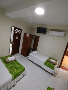 Ein Bett oder Betten in einem Zimmer der Unterkunft Hotel El Andino