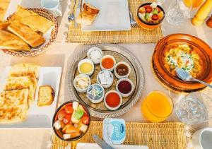 a table with many plates of food on it at Berber Camp Merzouga in Merzouga