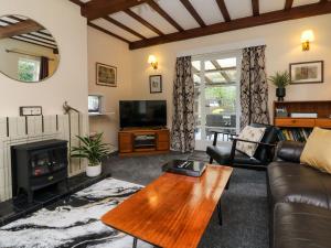 a living room with a couch and a fireplace at Barton Lodge in Minehead