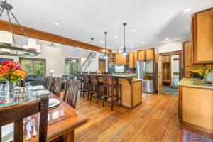 an open kitchen and living room with wooden floors and a dining room at Big Sky Cabin in Nashville