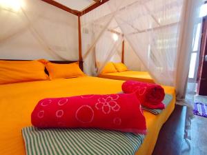 Postel nebo postele na pokoji v ubytování Pearl Deluna Resort Mirissa