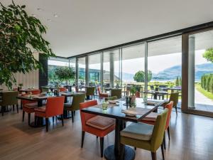 a restaurant with tables and chairs and large windows at The Europe Hotel & Resort in Killarney