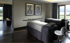 a bedroom with two beds and a window at The Europe Hotel & Resort in Killarney