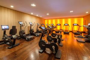 a gym with a row of treadmills and exercise bikes at The Europe Hotel & Resort in Killarney