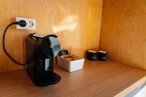 a coffee maker sitting on top of a wooden table at Aurora Igloo South in Hella