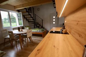 a kitchen and dining room with a table and chairs at Kemp na Zálabí in Vědomice